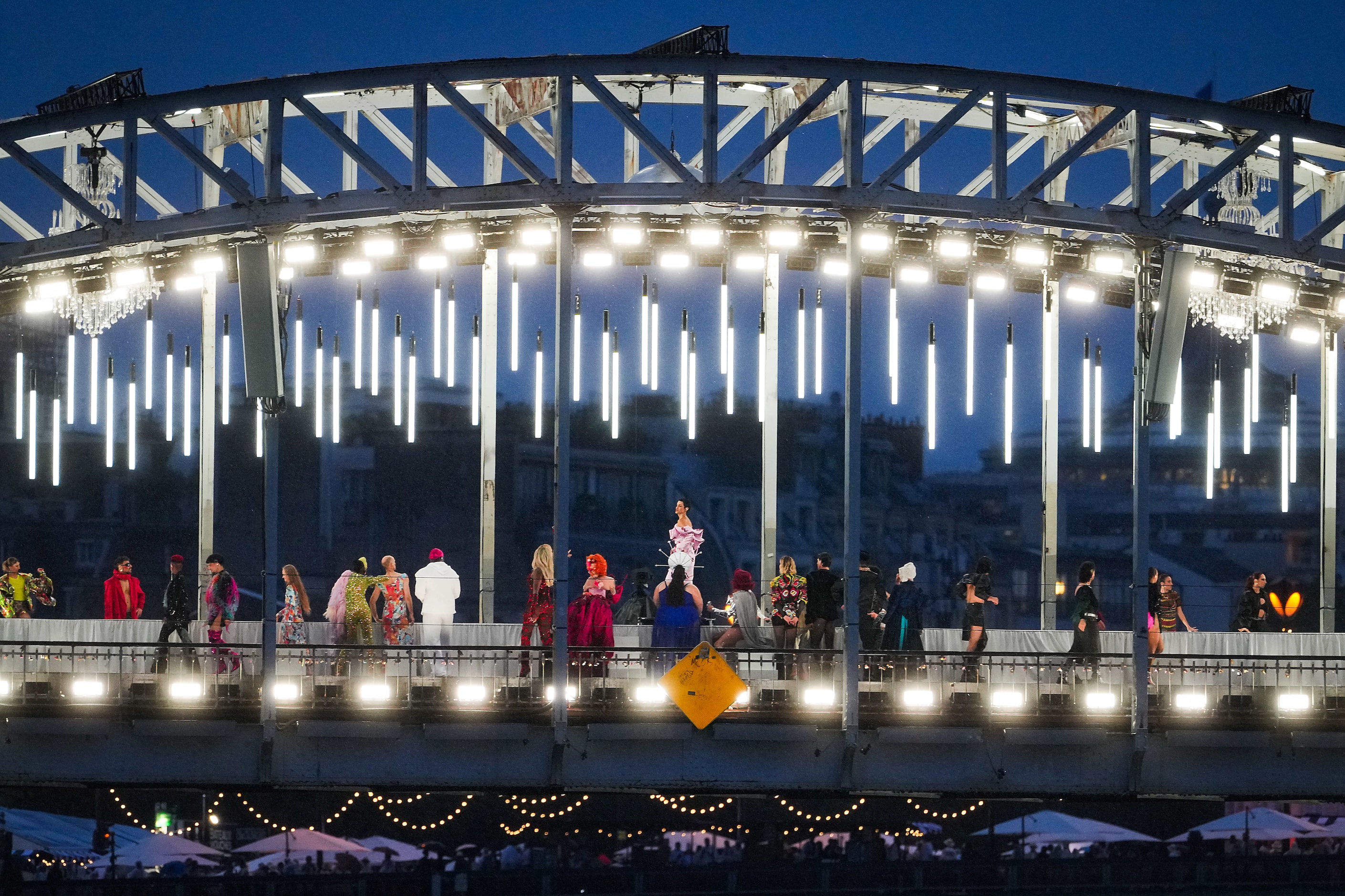 Performers are seen on La  Debilly Footbridge during opening ceremonies for the 2024 Summer...