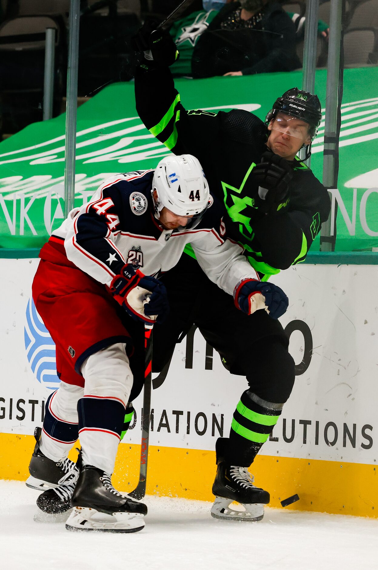 Dallas Stars right wing Denis Gurianov (34) is pushed to the wall by Columbus Blue Jackets...