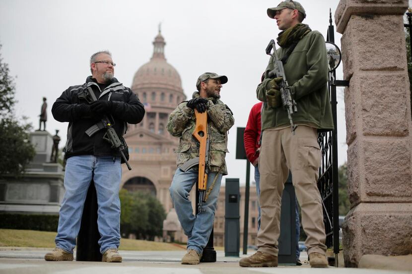 In this Jan. 13 file photo, gun rights advocates carry rifles while protesting outside the ...