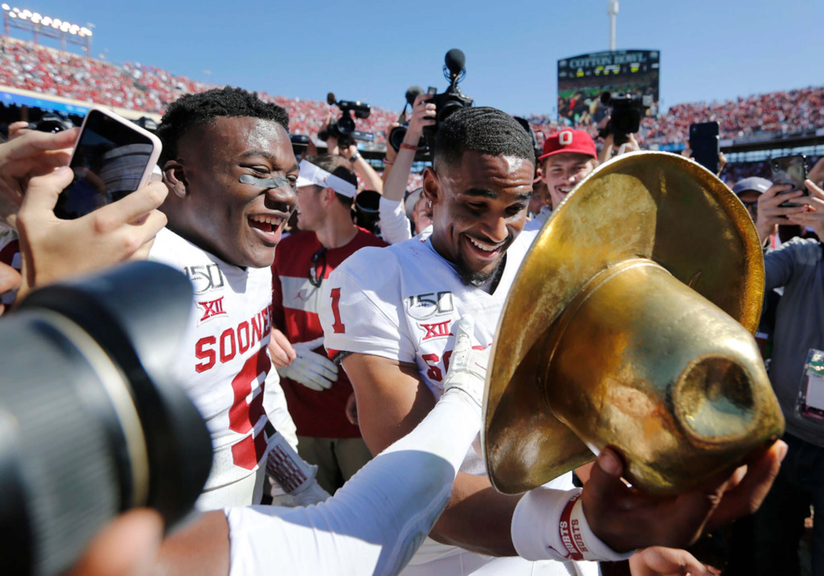 Oklahoma Sooners quarterback Jalen Hurts (1) tries on the Golden Hat in celebration as...