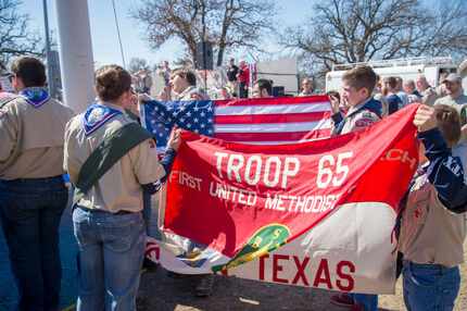 Boy Scouts color guard members in Denton present the U.S. flag and the Troop 65 flag to...