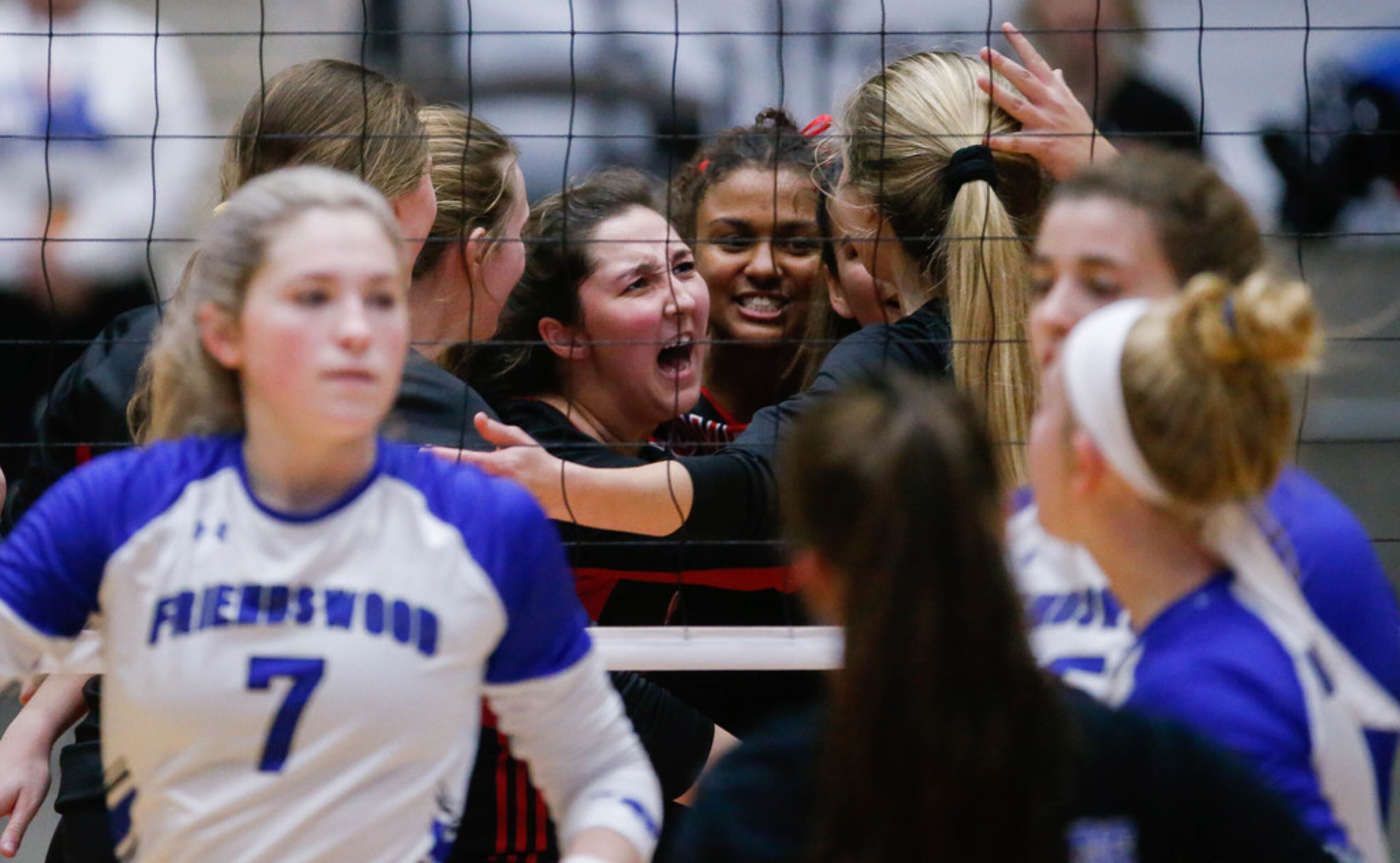The Lovejoy Leopards celebrate after scoring against Friendswood in the first set of a class...