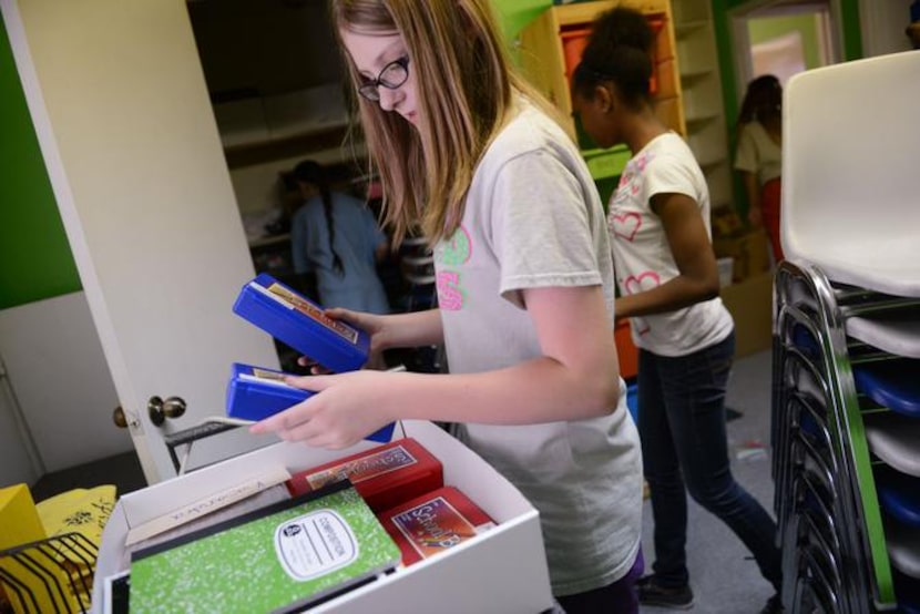 
Volunteer Lauren Braddy packs up items for Bea's Kids, an organization that offers...