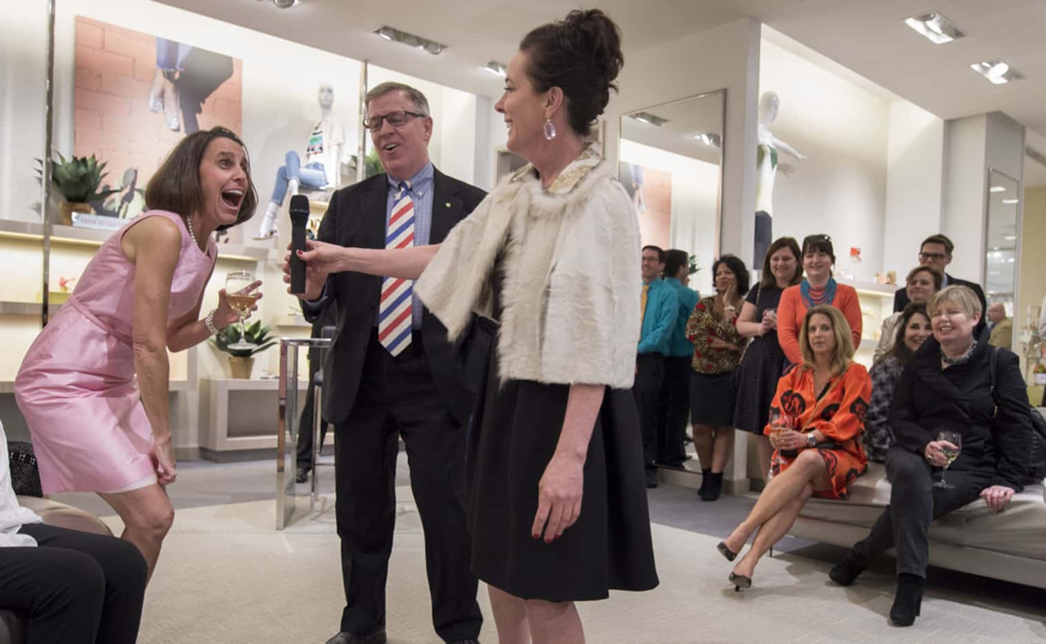 In 2016, Amy Thompson (left) reacted as Kate Spade hands her the microphone while Mark...