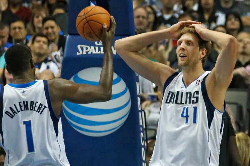 Dallas' Dirk Nowitzki, right, and Samuel Dalembert react to a missed Nowitzki shot in the...
