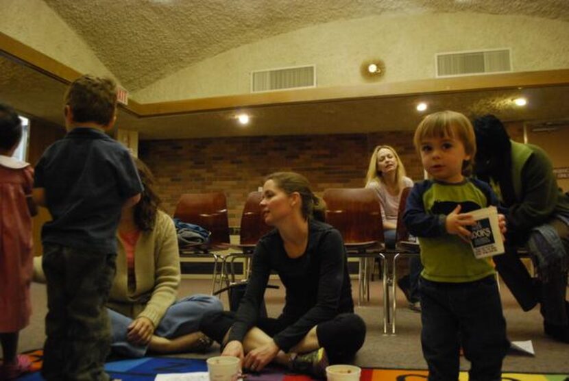 Connor Dunn (right) carries crayons during a coloring session at the library.