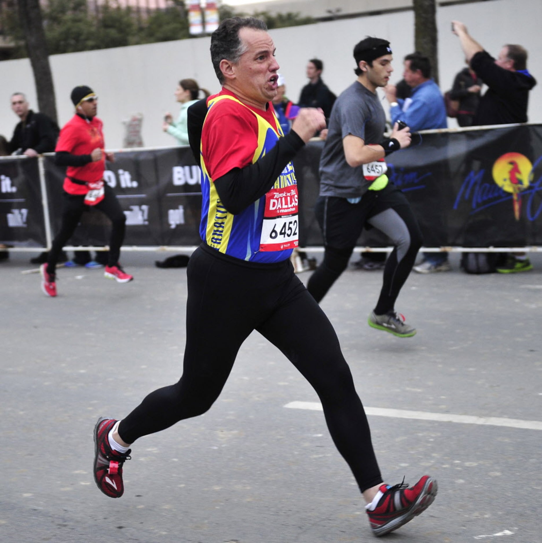 A runner takes off at a fast pace at the beginning of the Dallas Rock N' Roll half-marathon...