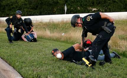 Photographer Chris Rusanowsky (right) is arrested just minutes after capturing the pepper...