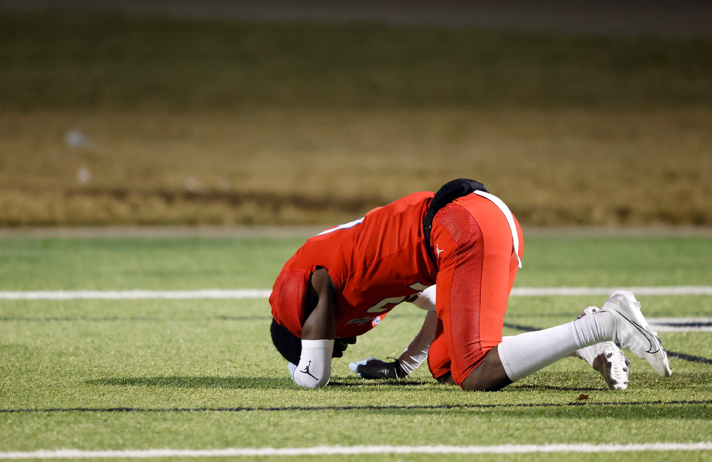 Midlothian Heritage’s Carter Kopecky (12) collapses in the end zone after the team lost to...