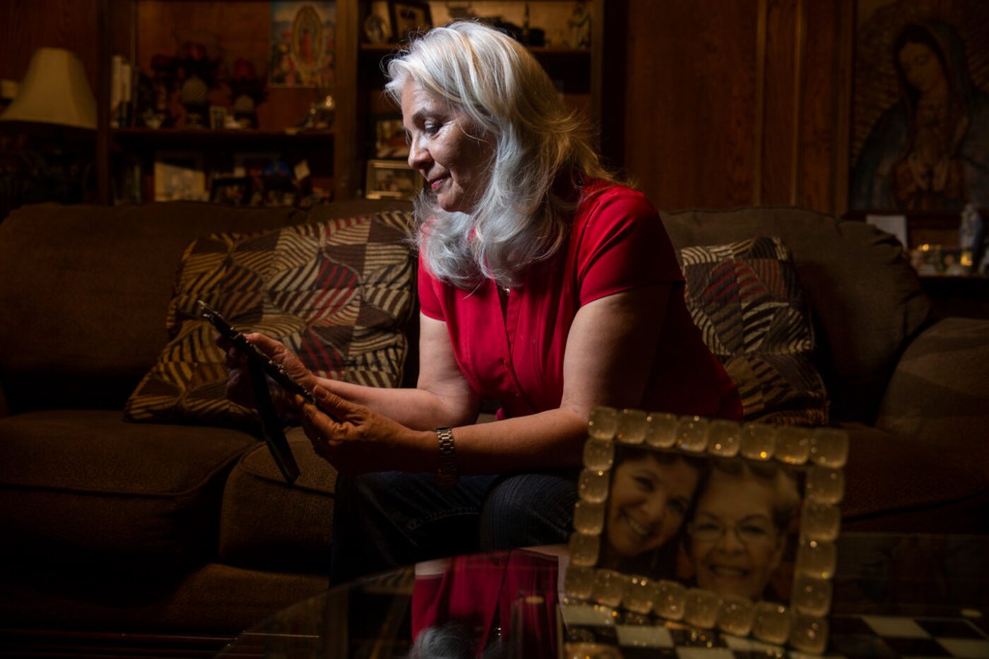 Rebecca Payan looks at a photograph of her mother, Ofelia Reyes, in her Garland home. Payan...