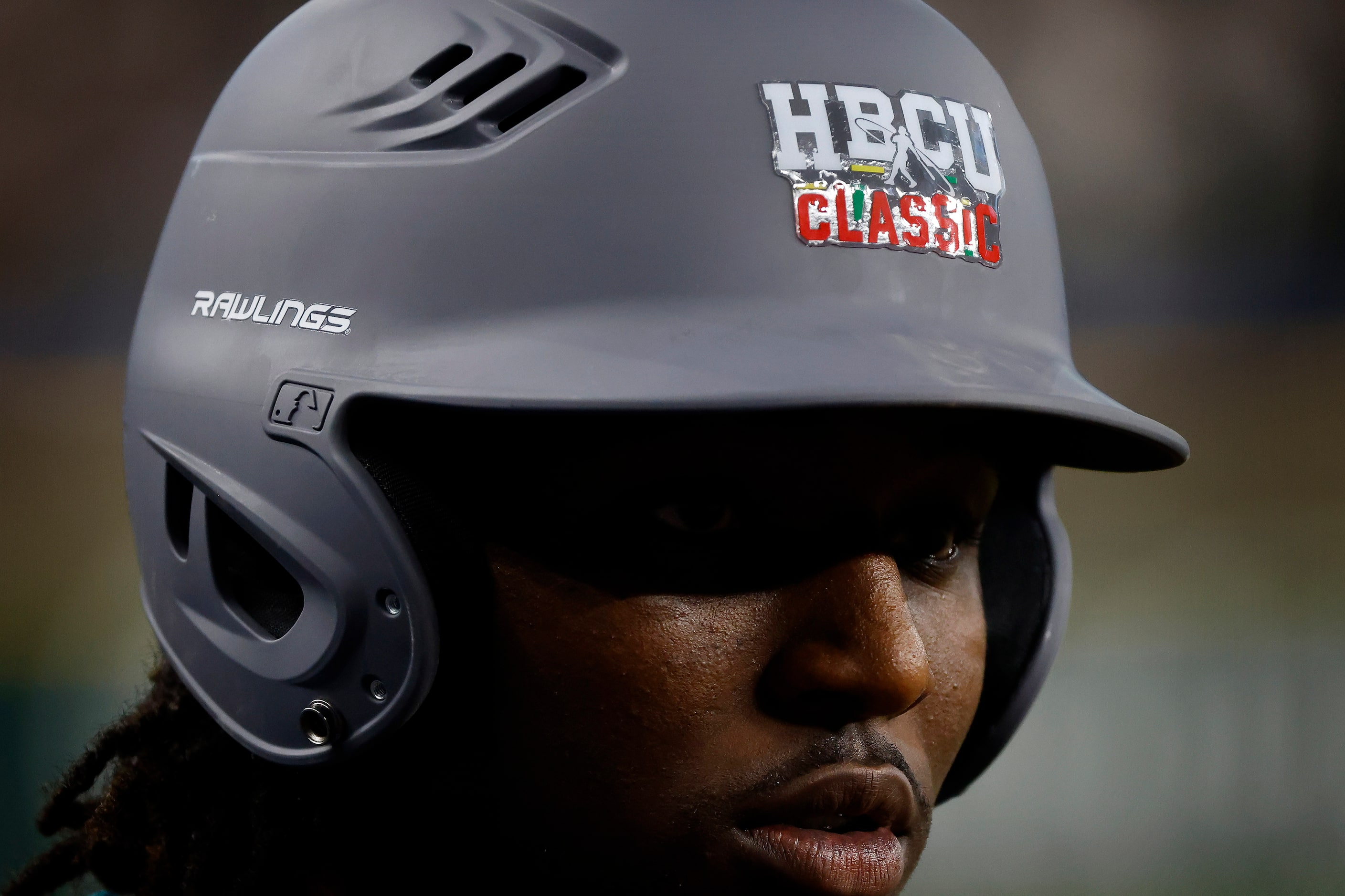 National League player Khyle Radcliffe dons a batting helmet before heading to the warm...