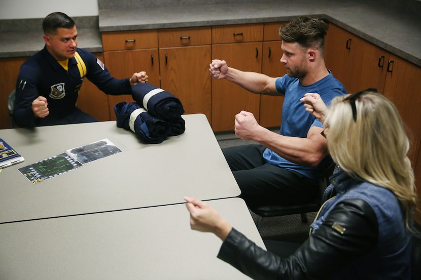 David Vobora (center) is briefed before a flight with the Blue Angels in a U.S. Navy F/A-18,...