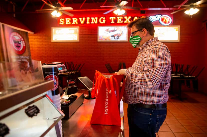 French hornist Brian Brown picks up a DoorDash order from Soulman's Bar-B-Que in Hurst.