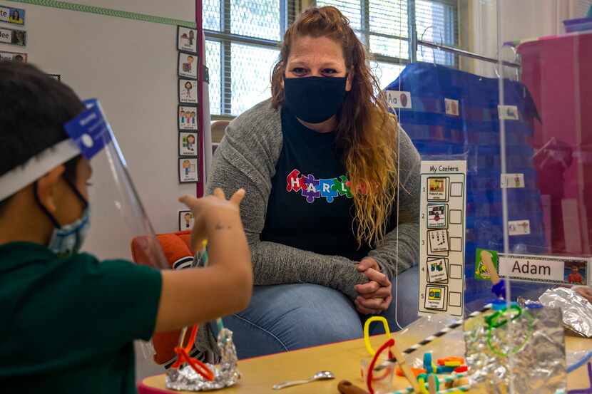 Pre-K 4 teacher Annie Pardee cheers on student Adam Renteria as he and his classmates work...