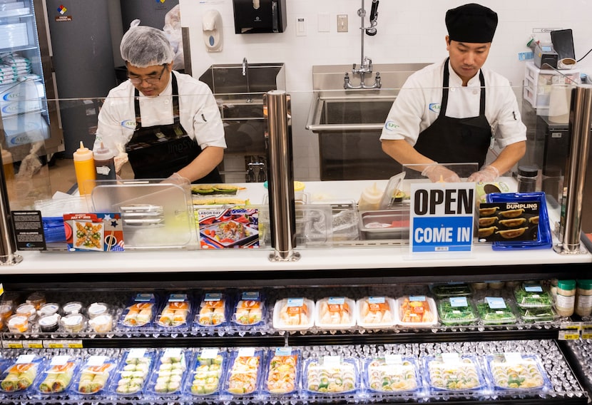 (From left) Second chef Biak Kung and head chef Henry Thang prepare sushi at the Albertsons...