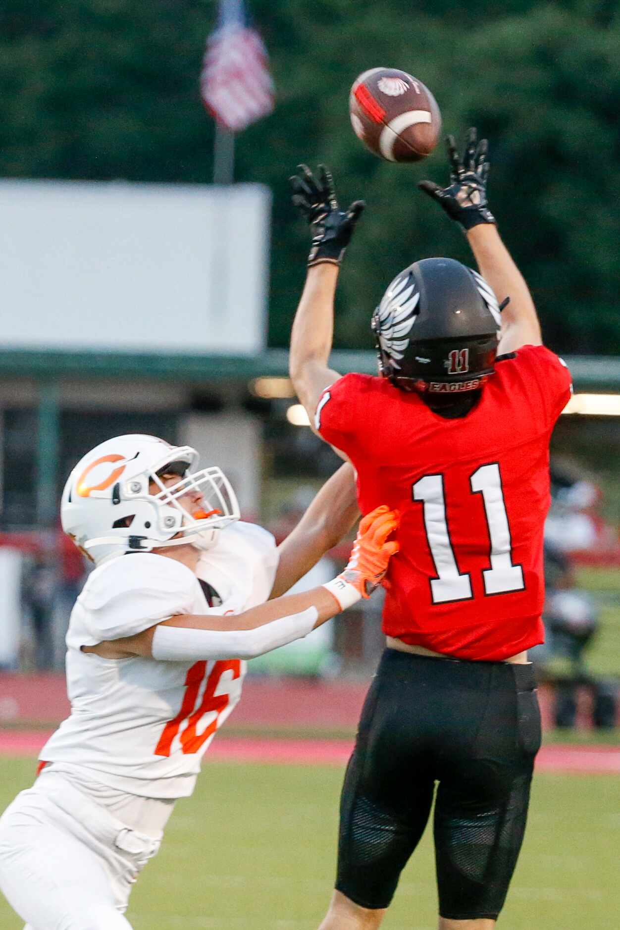 Argyle wide receiver Ward McCollum (11) reaches to make the catch over Celina defensive end...