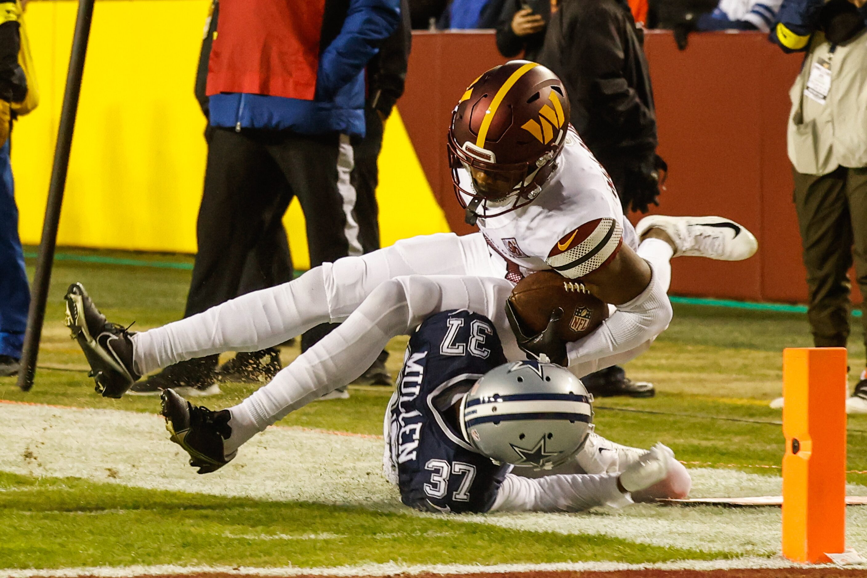 Dallas Cowboys cornerback Trayvon Mullen (37) tackles Washington Commanders wide receiver...