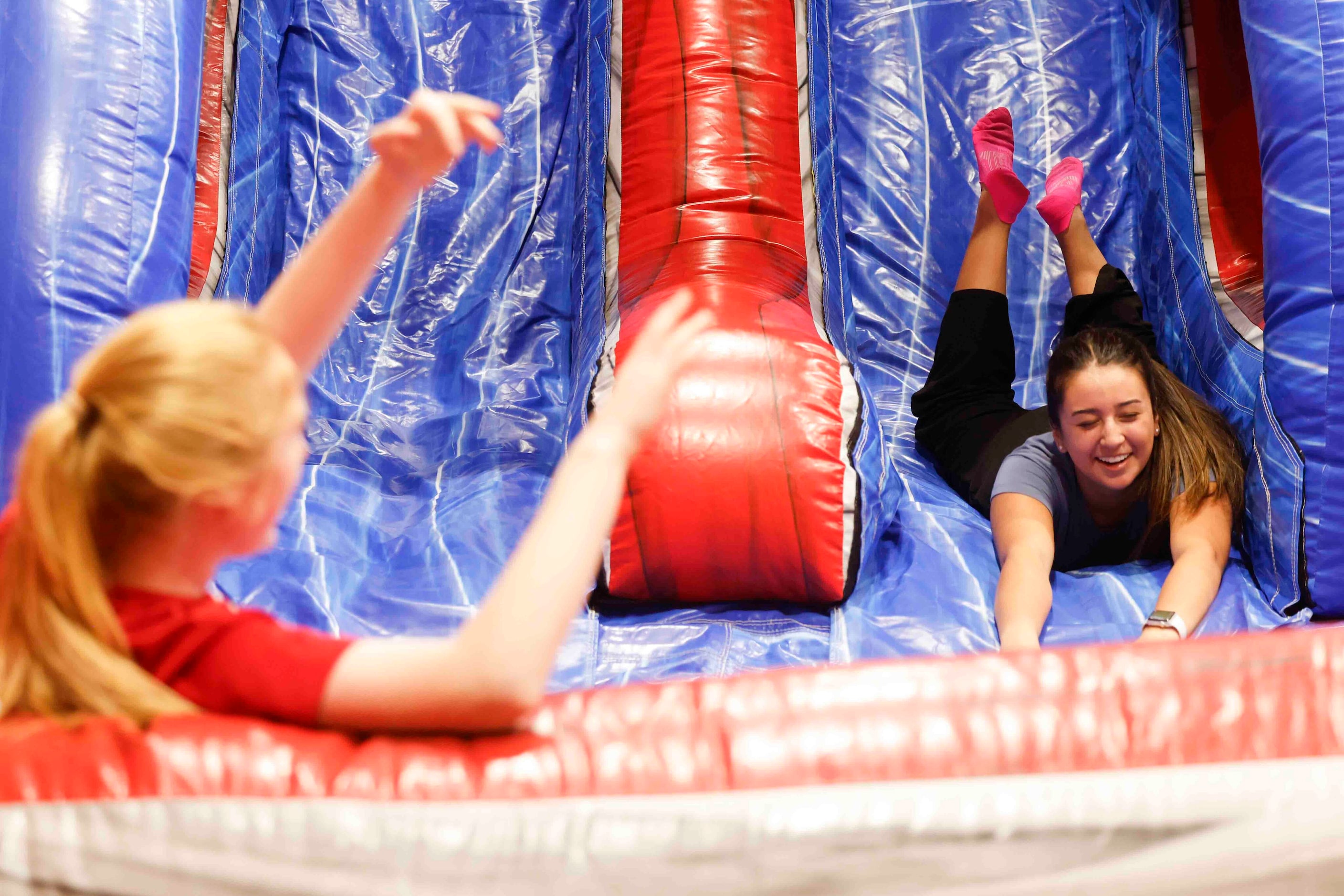 Sophomore Caroline Stewart (left) reacts towards Isabel Acosta as she rolls down an...