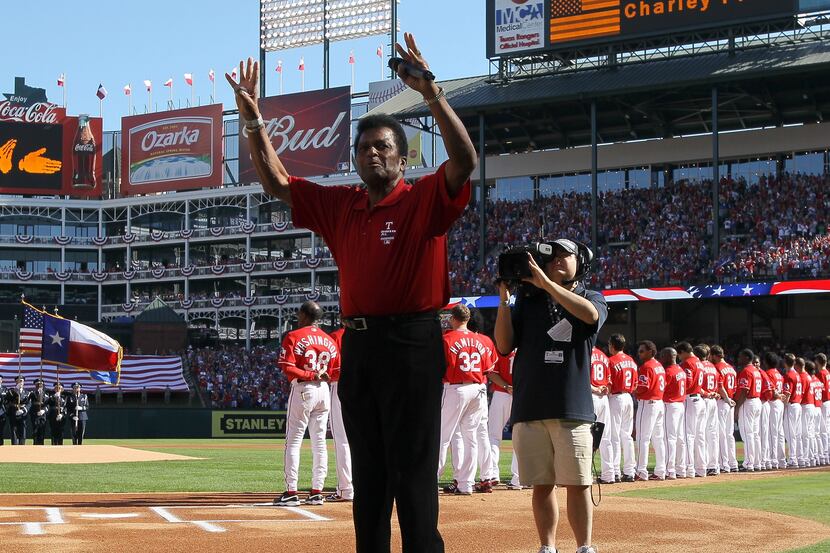 FILE — Country singer Charley Pride waves after singing the national anthem before game...