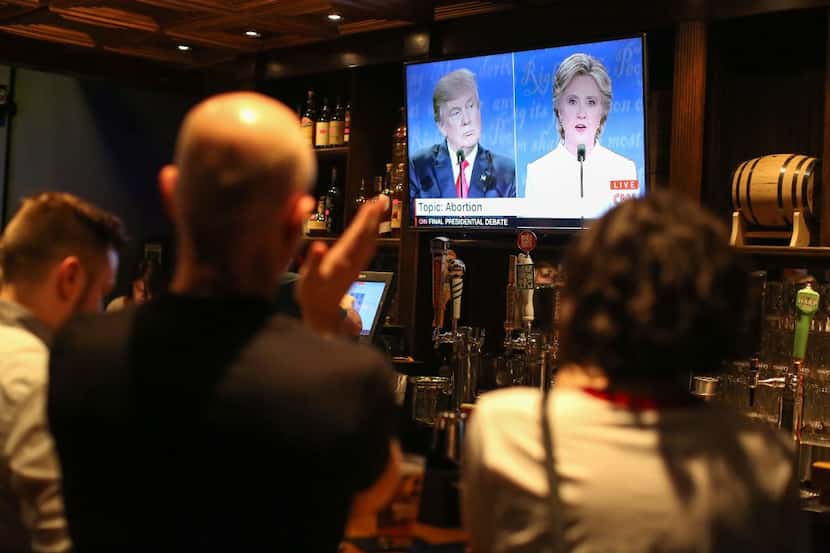 People watch the third presidential debate between Hillary Clinton and Donald Trump at...
