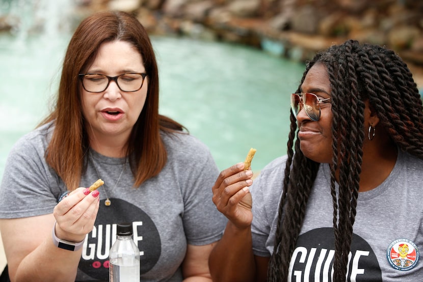 Sara Burgos (left) and Dawn Burkes react to the fried green beans that come on the side of...