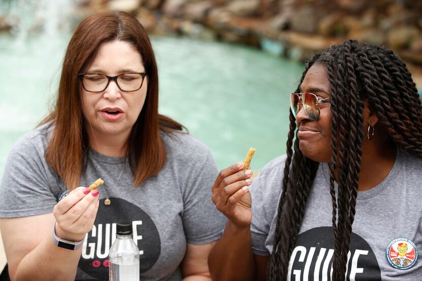 Sara Burgos (left) and Dawn Burkes react to the fried green beans that come on the side of...