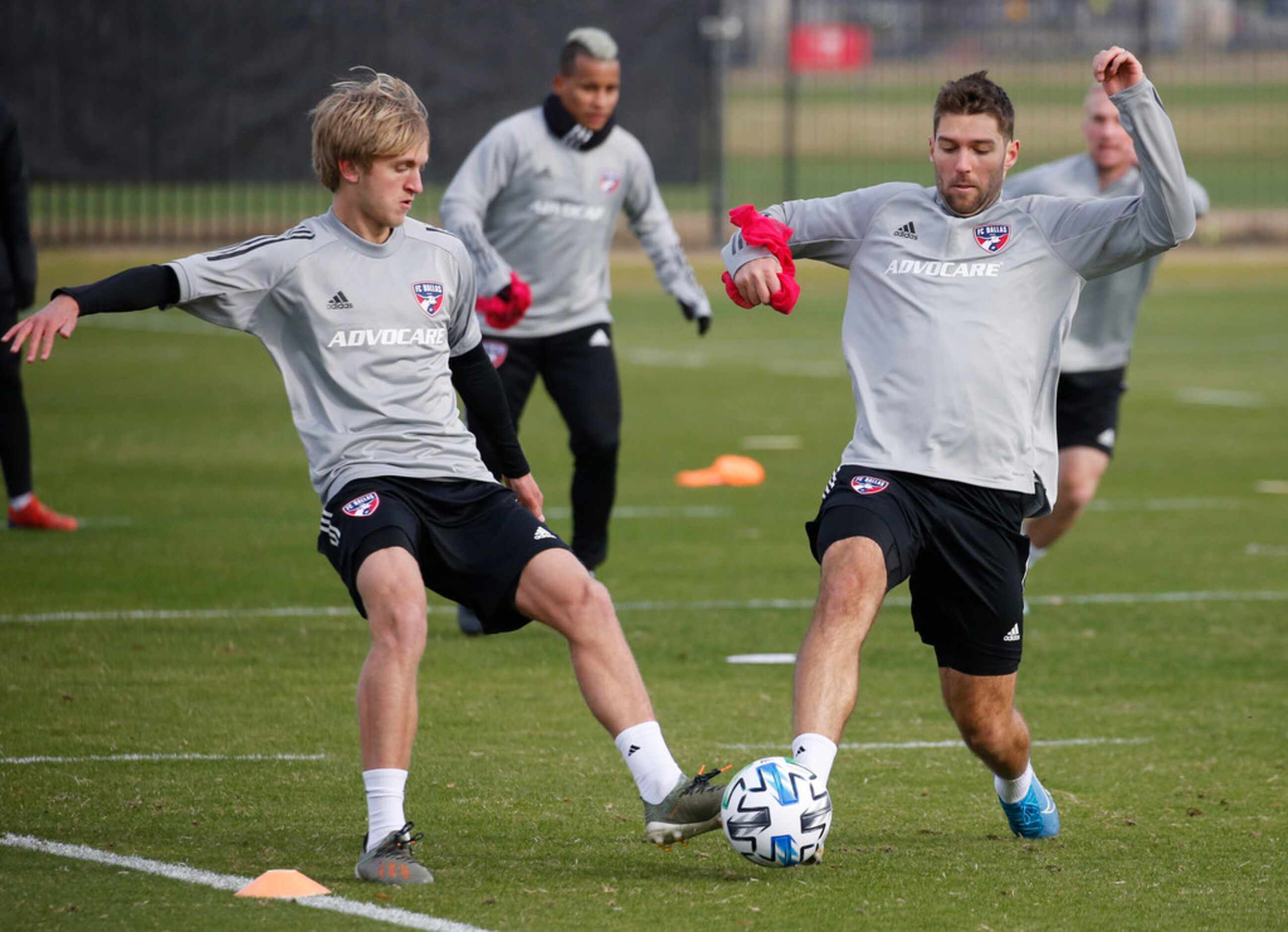 FC Dallas Thomas Roberts (23) and FC Dallas midfielder Ryan Hollingshead (12) compete during...