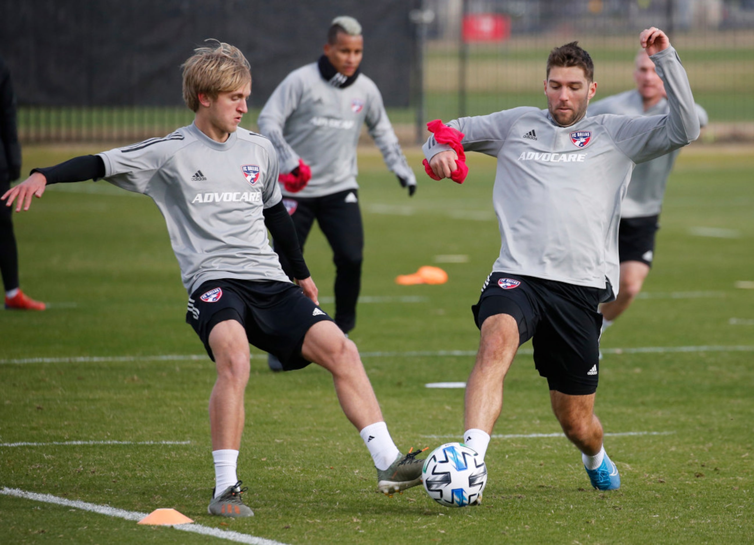 FC Dallas Thomas Roberts (23) and FC Dallas midfielder Ryan Hollingshead (12) compete during...