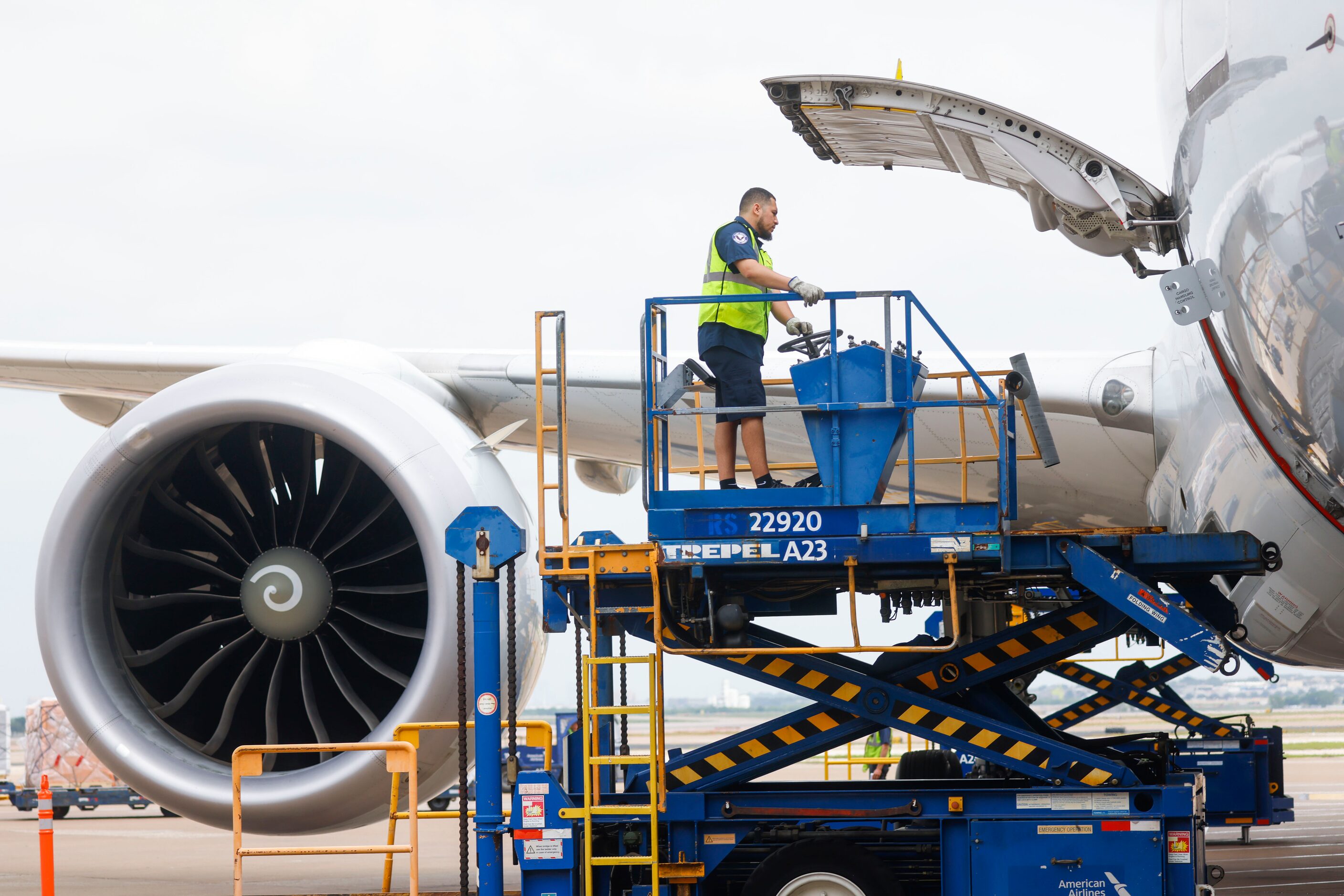 Members of the ground crew work on an American Airlines flight on Tuesday, May 9, 2023 at...