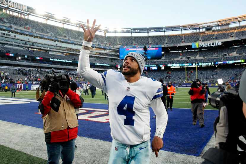 Dallas Cowboys quarterback Dak Prescott (4) tosses his towel to fans after they beat the New...