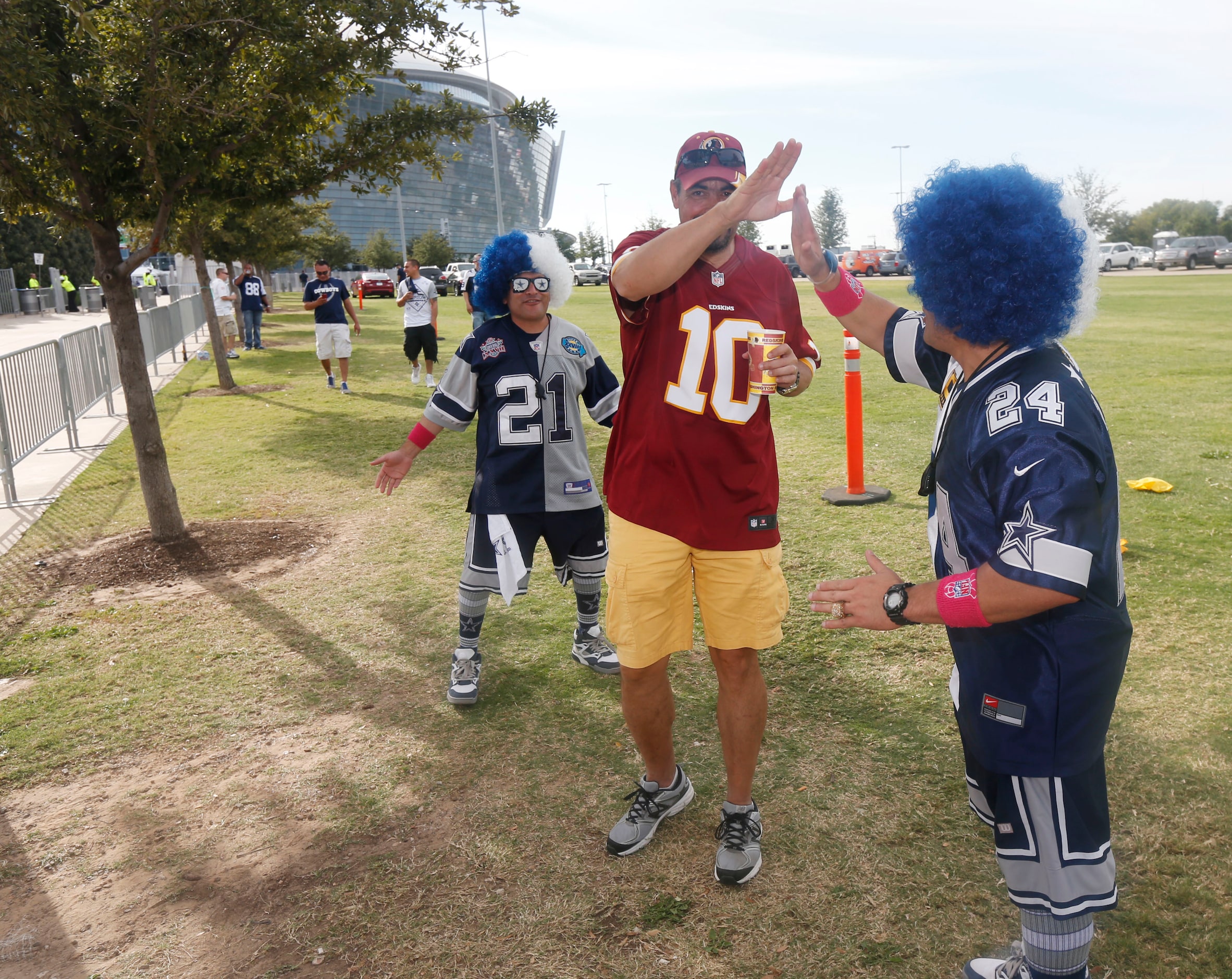 Dallas Cowboys fans Chris Saucedo, left, and Stephen Saucedo, right,  tease Washington...