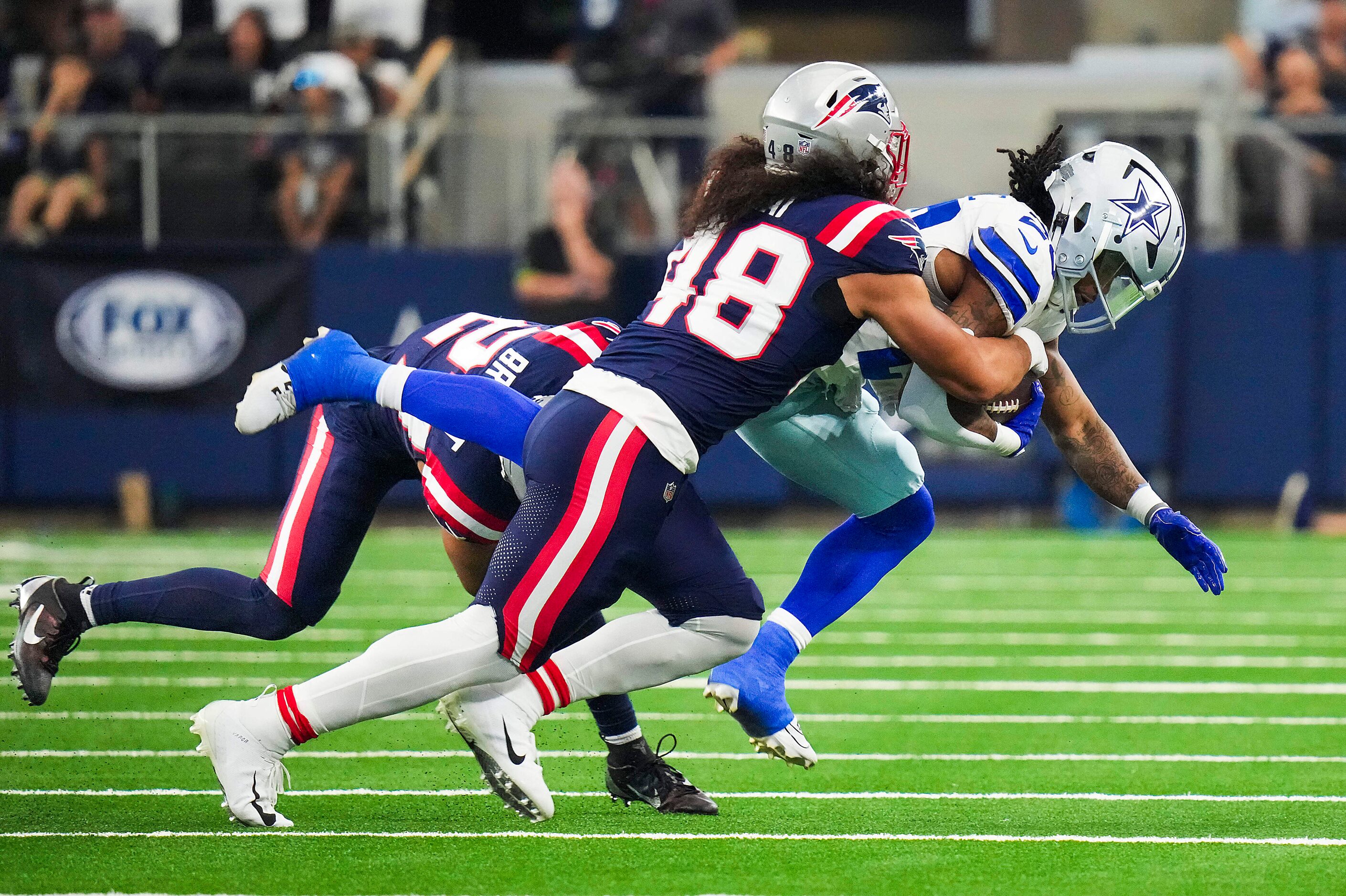 Dallas Cowboys running back Rico Dowdle (23) is brought down by New England Patriots...