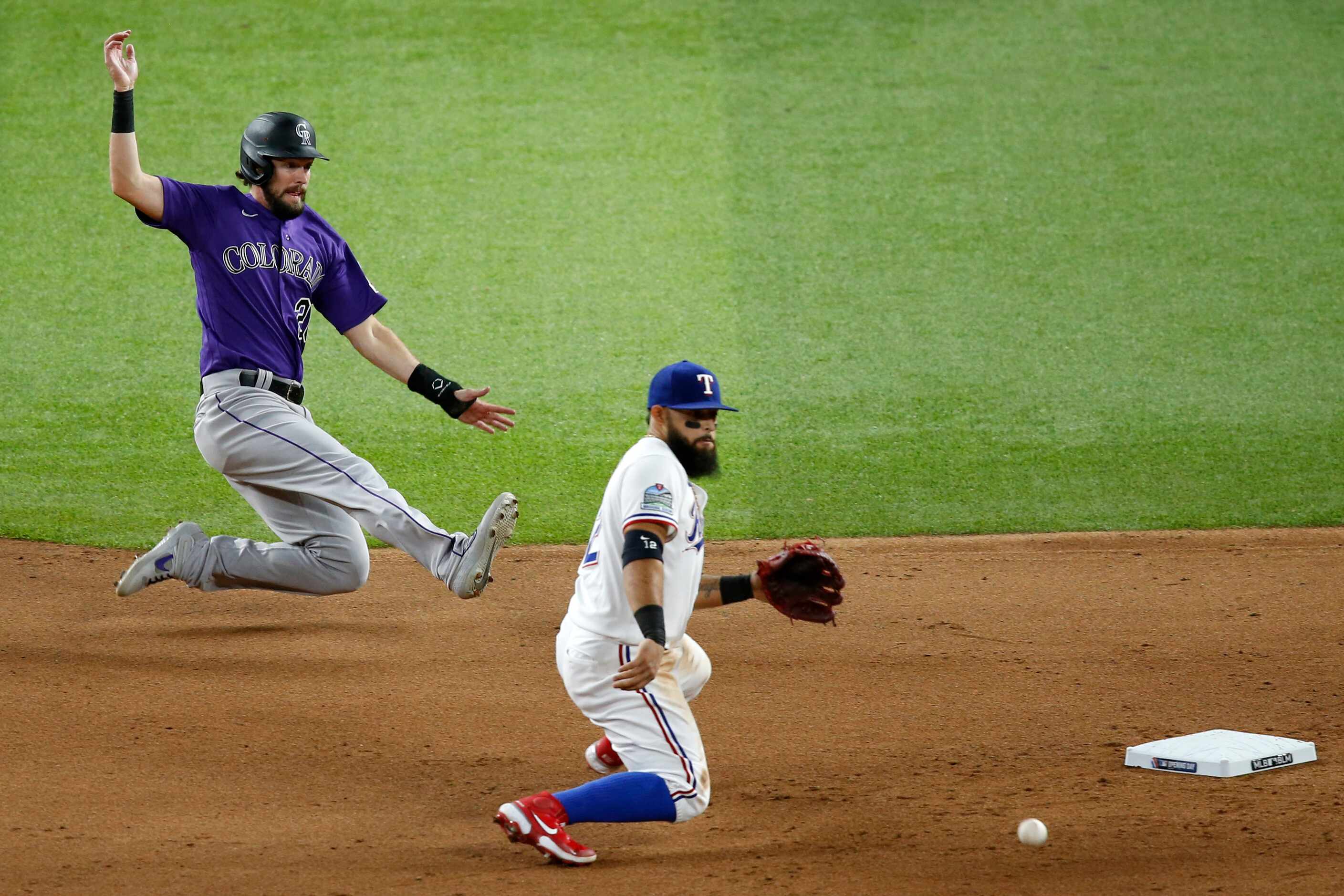 Colorado Rockies left fielder David Dahl (26) safely slides into second base as Texas...