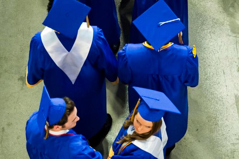 Graduating seniors lined up  to walk into the arena during the Frisco High School graduation...