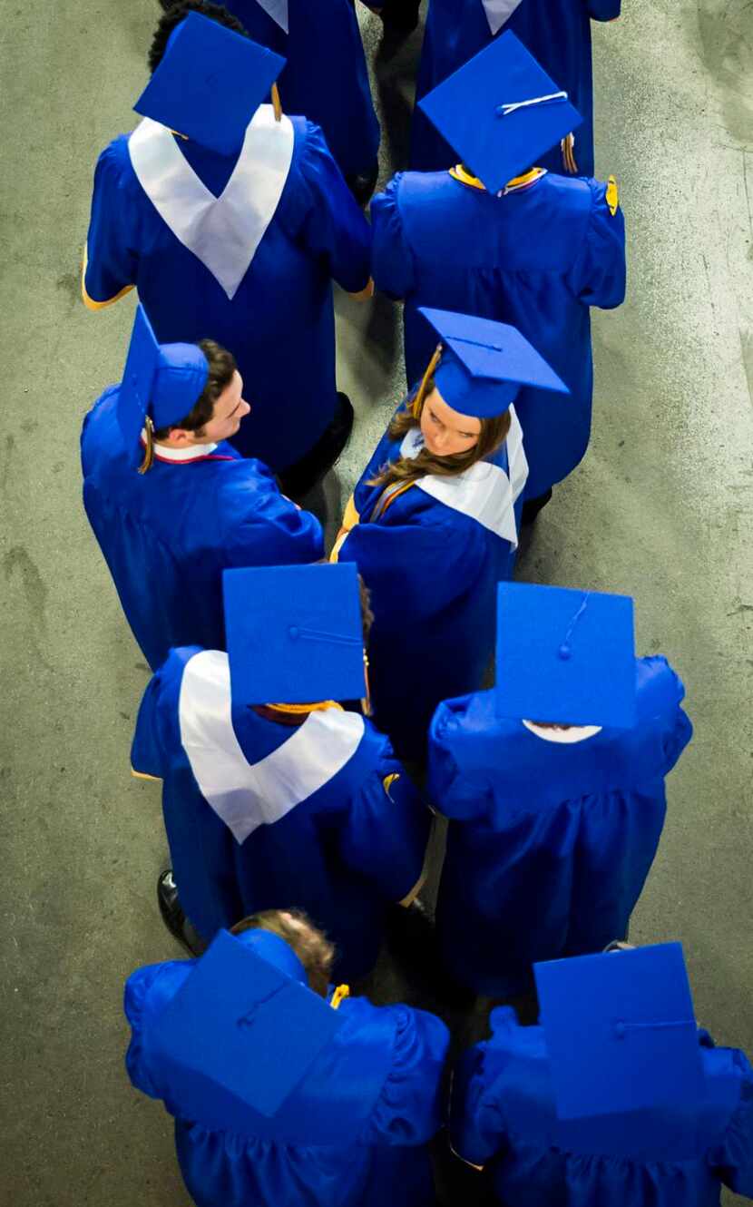 Graduating seniors lined up  to walk into the arena during the Frisco High School graduation...