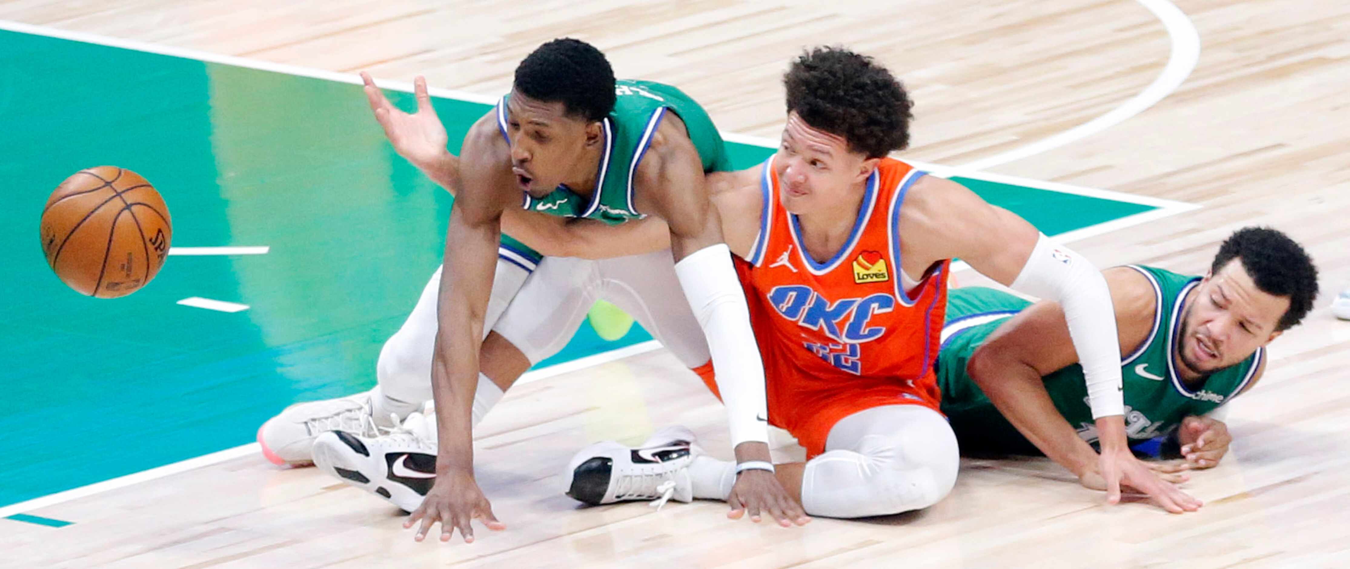 Oklahoma City Thunder center Isaiah Roby (22) looses the ball after being tackled by Dallas...