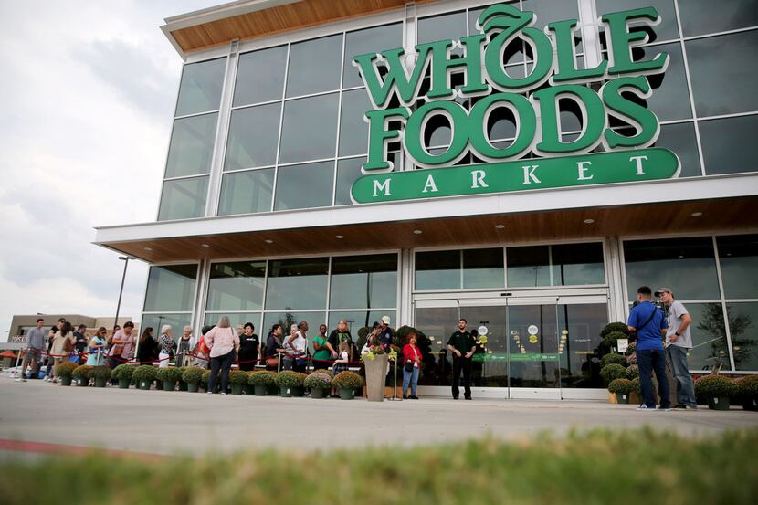 Shoppers line up outside Whole Foods Market during a pre-shopping event at the new Whole...