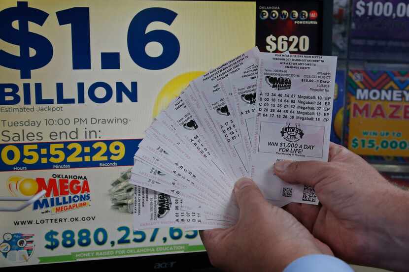 A customer, who did not want to be identified, displays the $200 worth of Mega Millions...