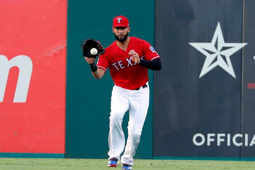 Texas Rangers' Nomar Mazara fields a run-scoring single by Los Angeles Angels' Kole Calhoun...