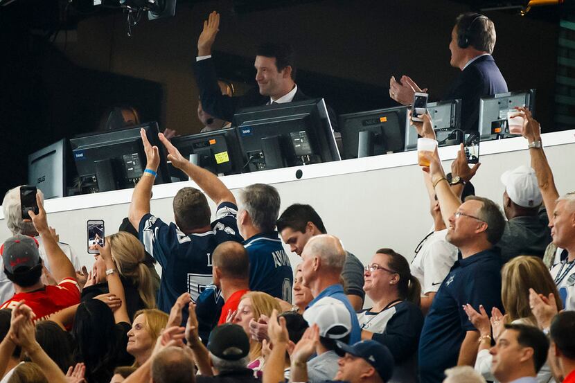 Former Dallas Cowboys quarterback  Tony Romo waves to the crowd from the broadcast booth as...