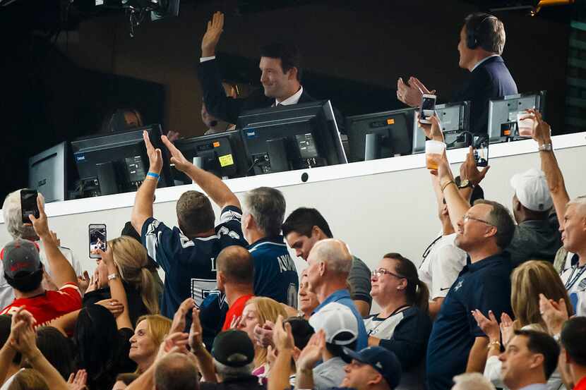 Former Dallas Cowboys quarterback  Tony Romo waves to the crowd from the broadcast booth as...