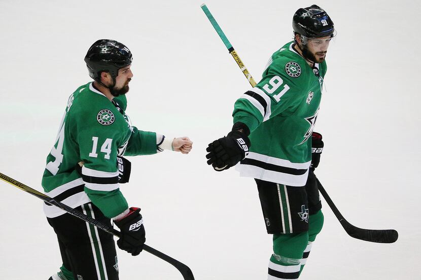 Dallas Stars left wing Jamie Benn (14) is congratulated by center Tyler Seguin (91) after...