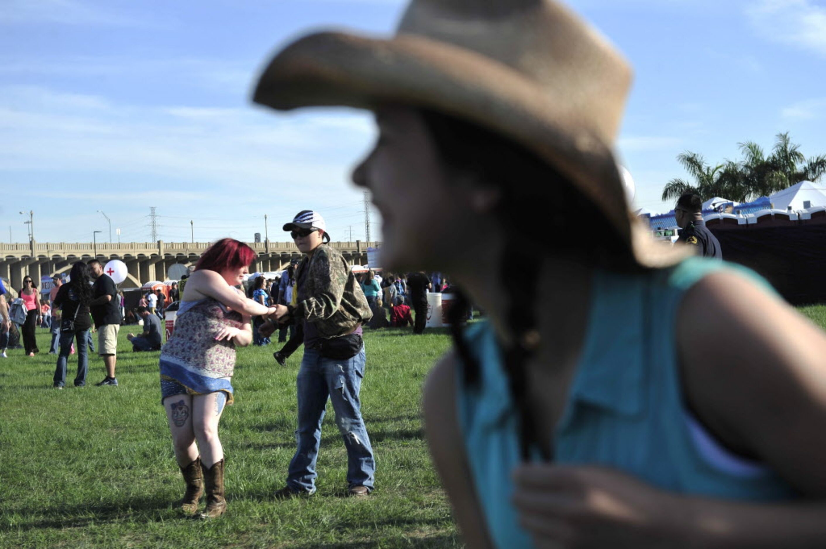 Samantha Ballesteros (center) spins Destiny Caddell (left) while their friend Teresa Rosa...