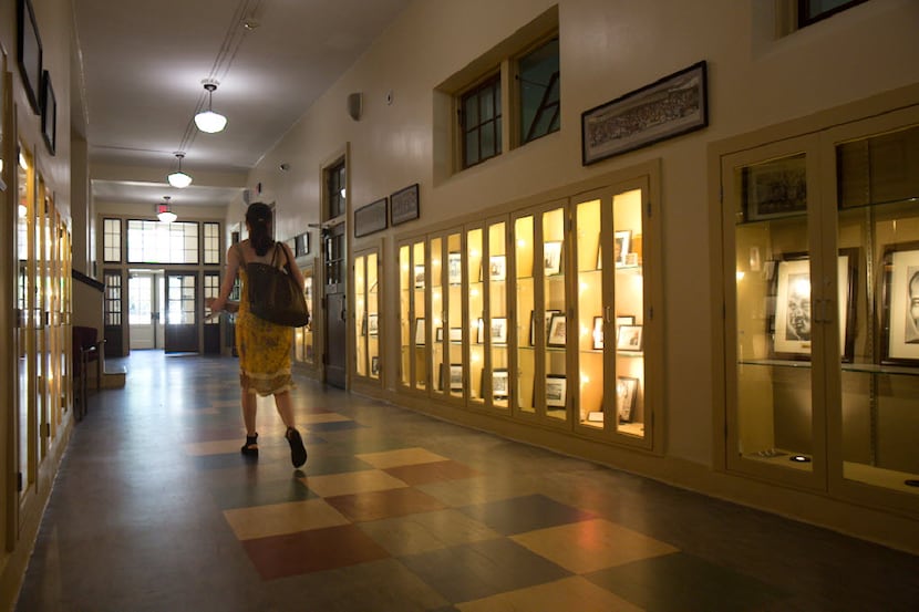 A woman walks down a hallway at Booker T. Washington High School for the Performing and...