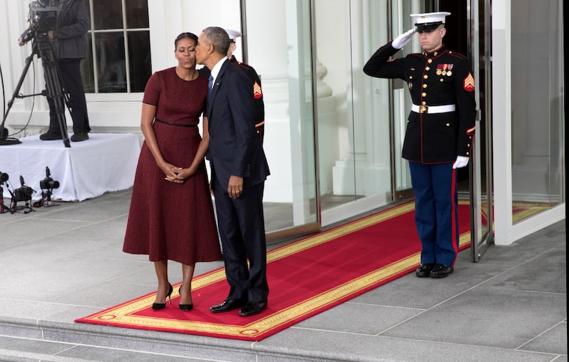 President Barack Obama kisses first lady Michelle Obama outside the White House (Stephen...