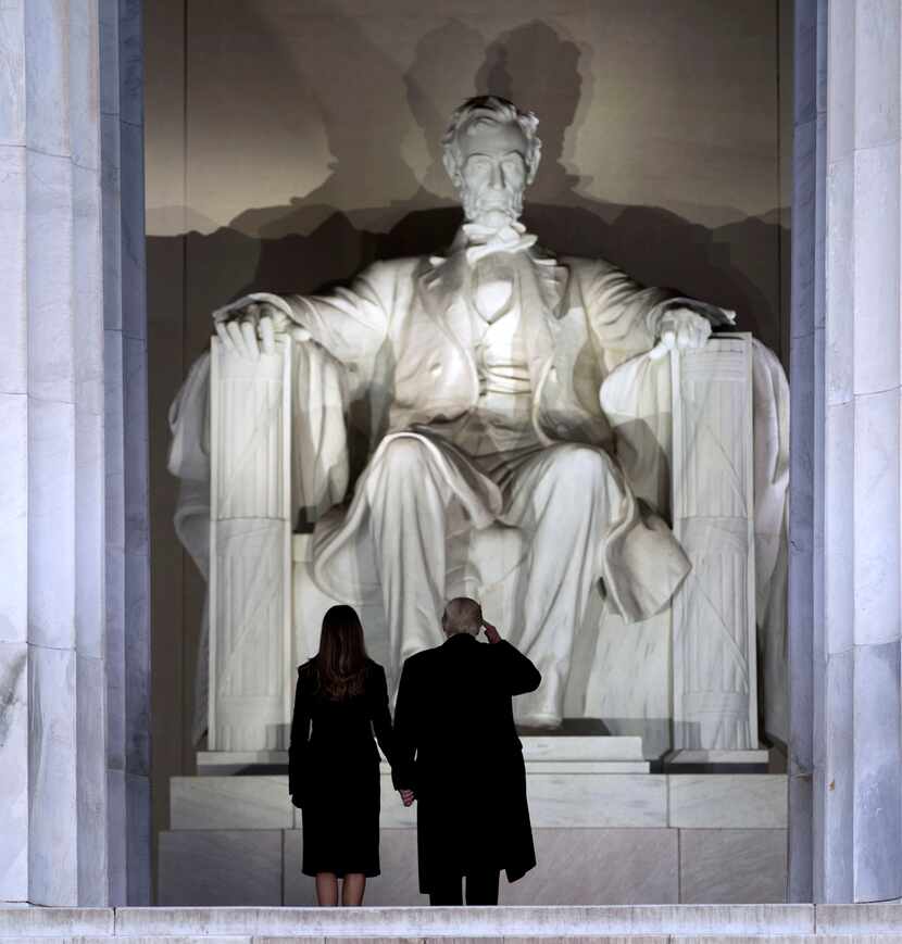 President-elect Donald Trump salutes Abraham Lincoln before he and his wife, Melania,...