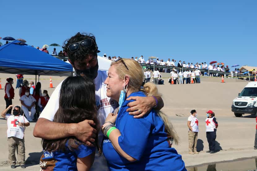 Nodelia López, 60, hugs her son Ramón Hermosillo, 33, and her granddaughter Valentina, 11,...