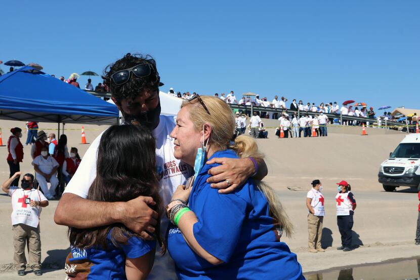 Nodelia López, 60, hugs her son Ramón Hermosillo, 33, and her granddaughter Valentina, 11,...