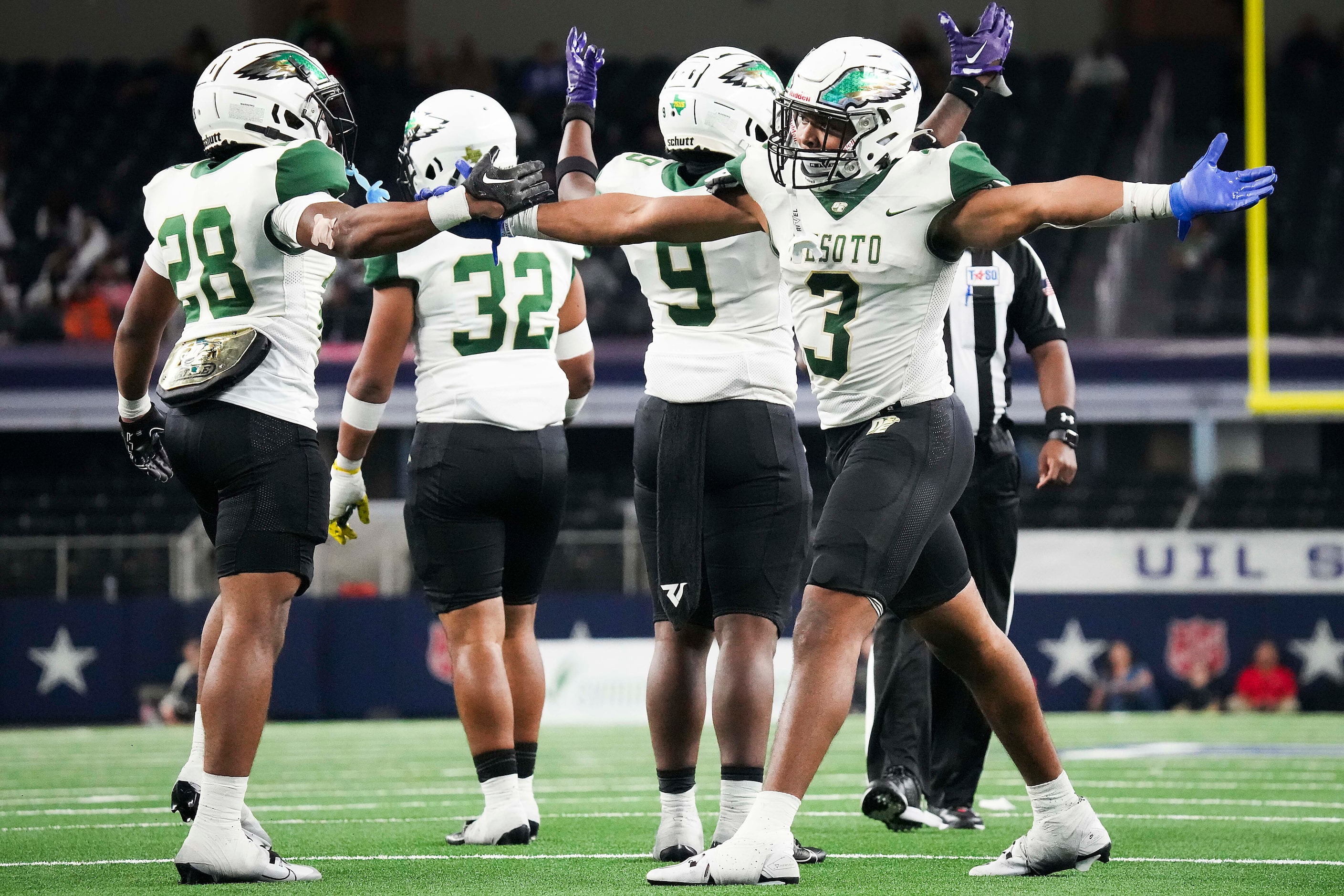 DeSoto linebacker Brandon Booker (3) celebrates with Jace Hill Douglas (28) after returning...