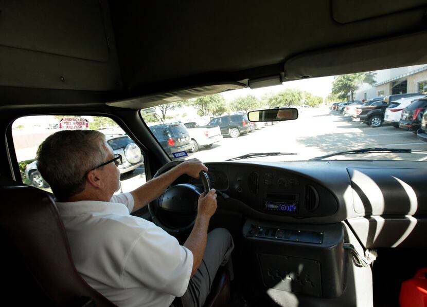 Jim Smith drives elderly voters in the 3e shuttle bus to a polling station in McKinney....